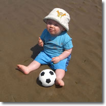My little boy Ben on the beach at 9 months old